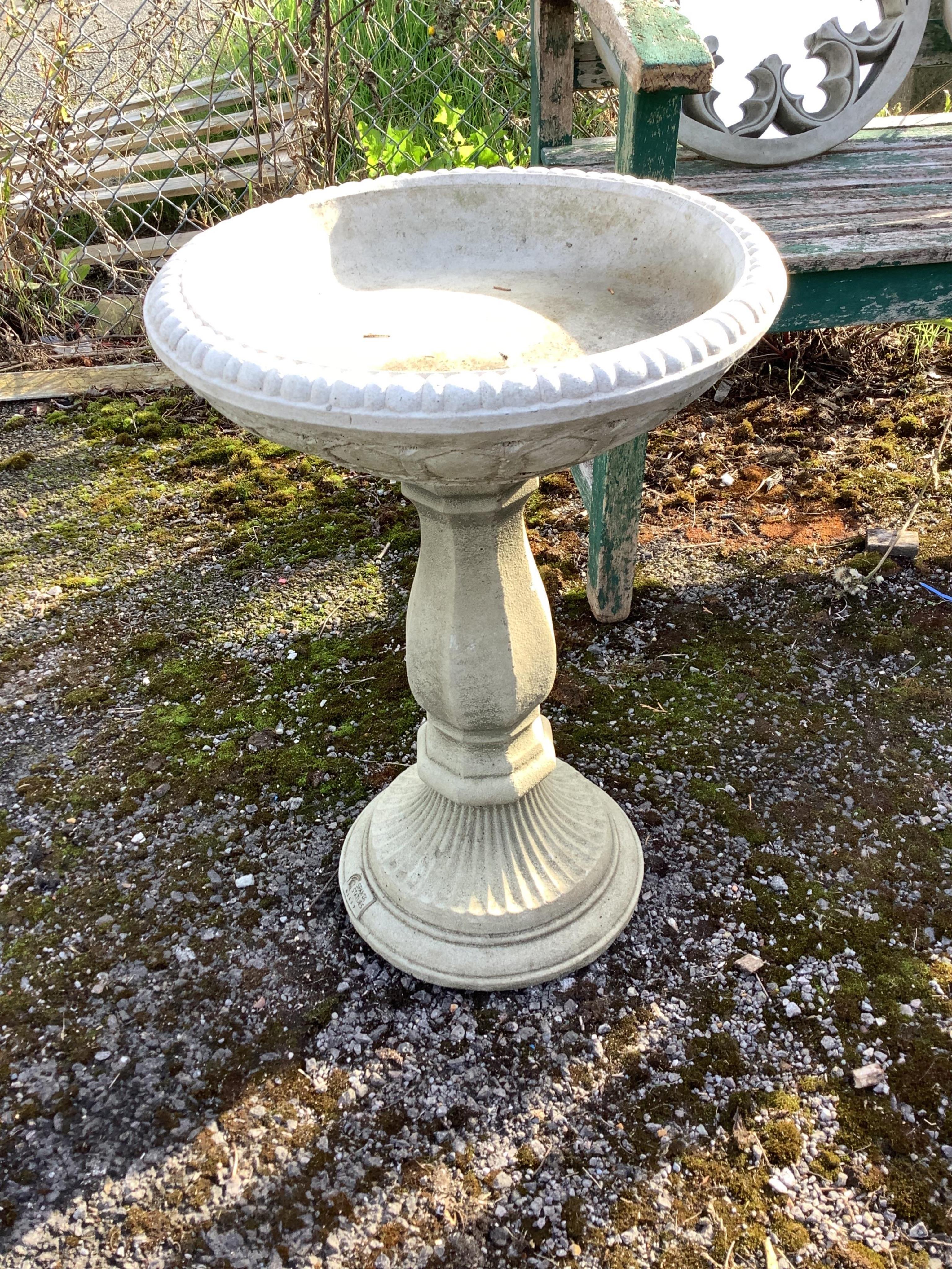 A Sparta Statues reconstituted stone pedestal bird bath, height 58cm, a more ornate larger bird bath, height 67cm and a reconstituted stone figural bird bath, width 46cm. Condition - pedestal bird baths fair to good, fig